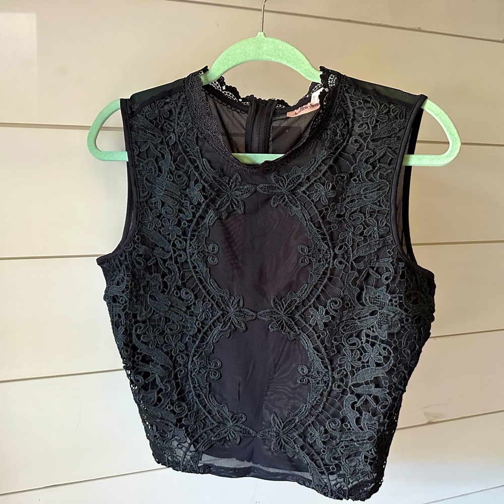 Black sleeveless shirt,size med,sheer w/lace detail, zipped back. Tags attached.